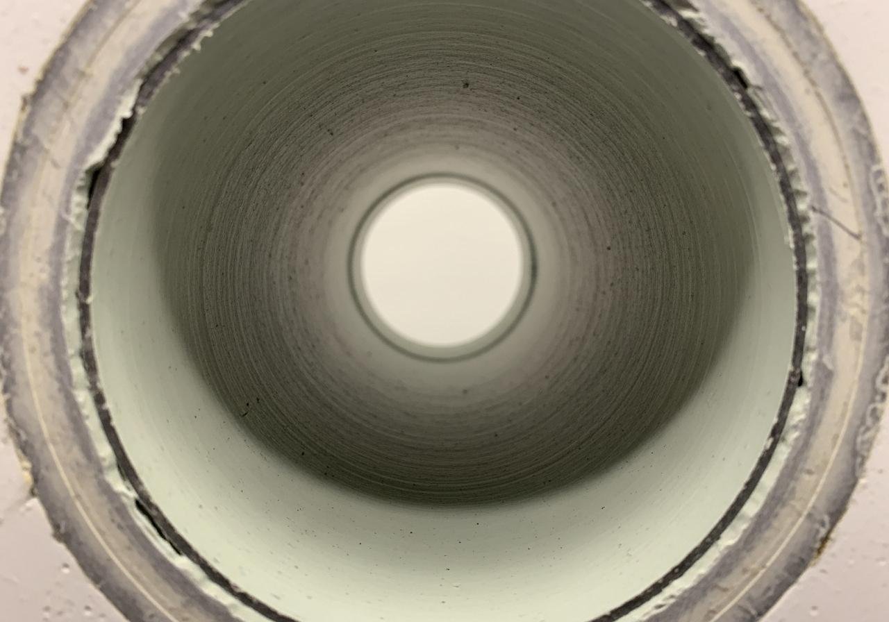 Clean marine plumbing pipe after one year with Commoderizer — only minor staining, no calcium buildup